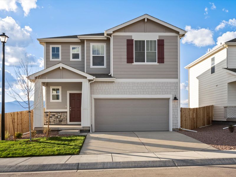 Front exterior of a new home in Lorson Ranch: The Trail Collection, Colorado Springs, CO, highlighting curb appeal (Image 1). Front exterior of a new home in Lorson Ranch: The Trail Collection, Colorado Springs, CO, highlighting curb appeal (Image 1).