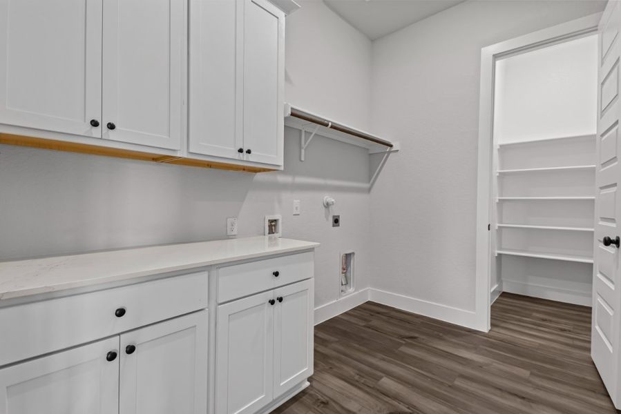 A kitchen with white cabinets.