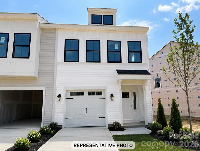 Front exterior of a new home in Ryder Park, Charlotte, NC, highlighting curb appeal (Image 1). Front exterior of a new home in Ryder Park, Charlotte, NC, highlighting curb appeal (Image 1).
