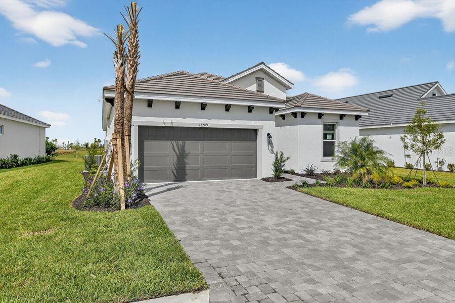 Front exterior of a new home in Coasterra Community Group Page, Palmetto, FL, highlighting curb appeal (Image 16).