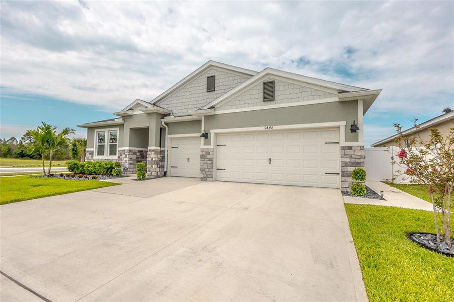 Front exterior of a new home in Harmony West, Harmony, FL, highlighting curb appeal (Image 24). Front exterior of a new home in Harmony West, Harmony, FL, highlighting curb appeal (Image 24).