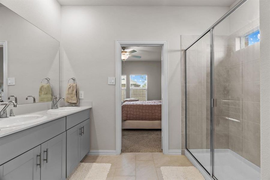 Bathroom with plenty of natural light, a stall shower, and double vanity Bathroom with plenty of natural light, a stall shower, and double vanity