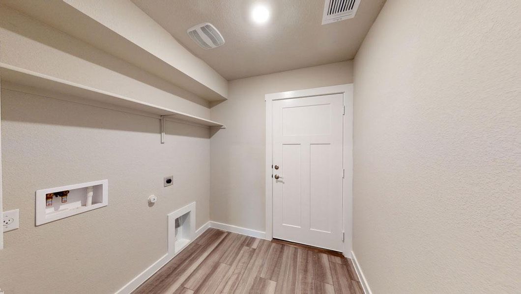 Laundry area with gas dryer hookup, light wood-style flooring, electric dryer hookup, and hookup for a washing machine