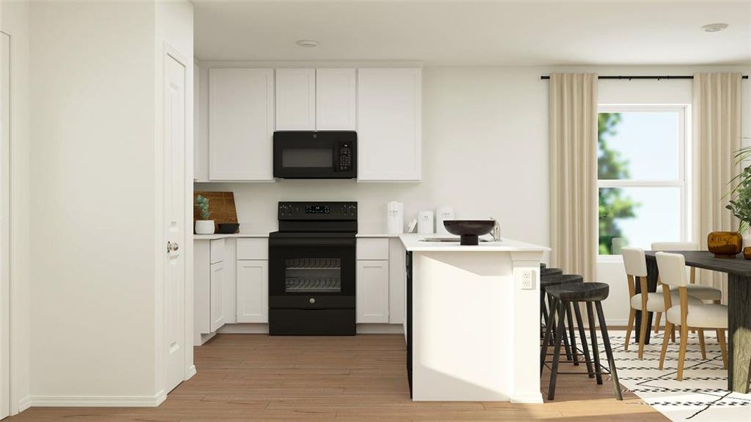 Kitchen featuring black appliances, light wood-type flooring, a breakfast bar, light countertops, and white cabinets Kitchen featuring black appliances, light wood-type flooring, a breakfast bar, light countertops, and white cabinets
