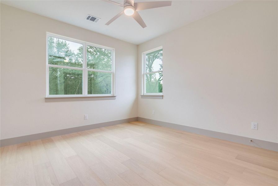 Spare room featuring light wood-type flooring and ceiling fan
