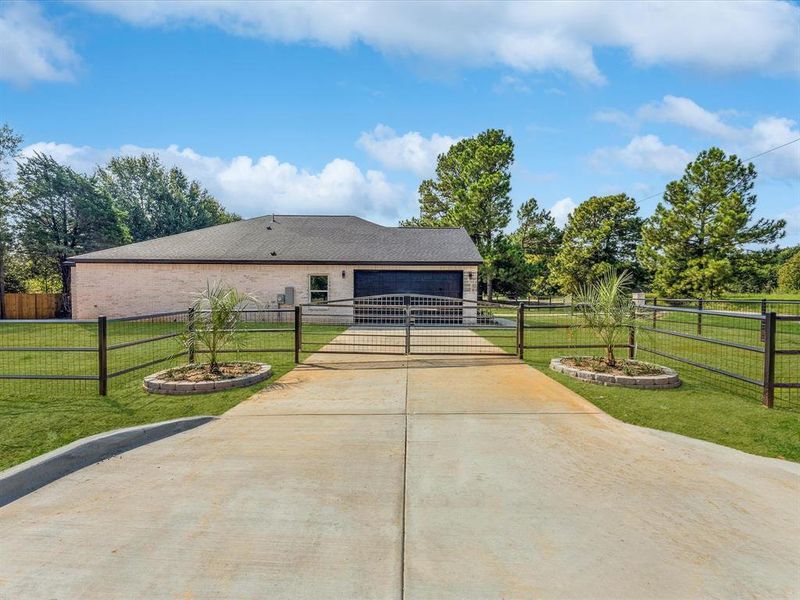 View of front of house with concrete driveway, brick siding, and an attached garage