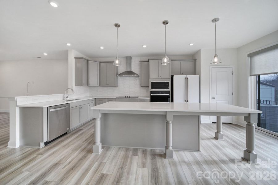 Chef's Kitchen - Quartz Countertops, Tile Backsplash, Large Breakfast Bar, Remote Shades, Balcony with Double Slider