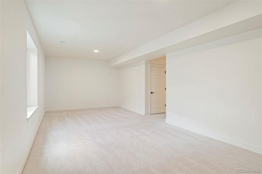 Versatile basement living space with open layout and natural light, offering flexibility for entertaining or everyday living