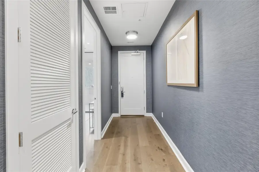 Doorway featuring wood finished floors and baseboards