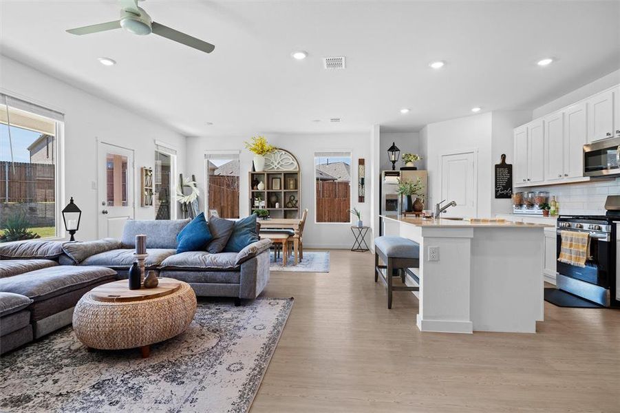 Living area featuring LVP style flooring, recessed lighting, and a ceiling fan Living area featuring LVP style flooring, recessed lighting, and a ceiling fan