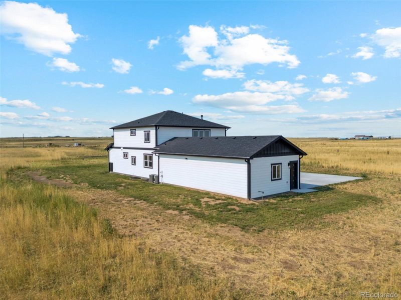 Front exterior of a new home in , Bennett, CO, highlighting curb appeal (Image 25).