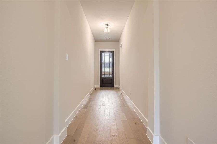 Entryway featuring light wood-type flooring and baseboards