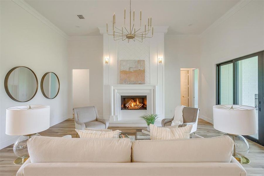 Living room with light hardwood / wood-style flooring and crown molding