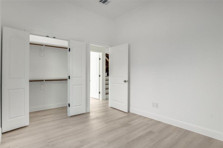 Unfurnished bedroom featuring light wood-style flooring and a closet Unfurnished bedroom featuring light wood-style flooring and a closet