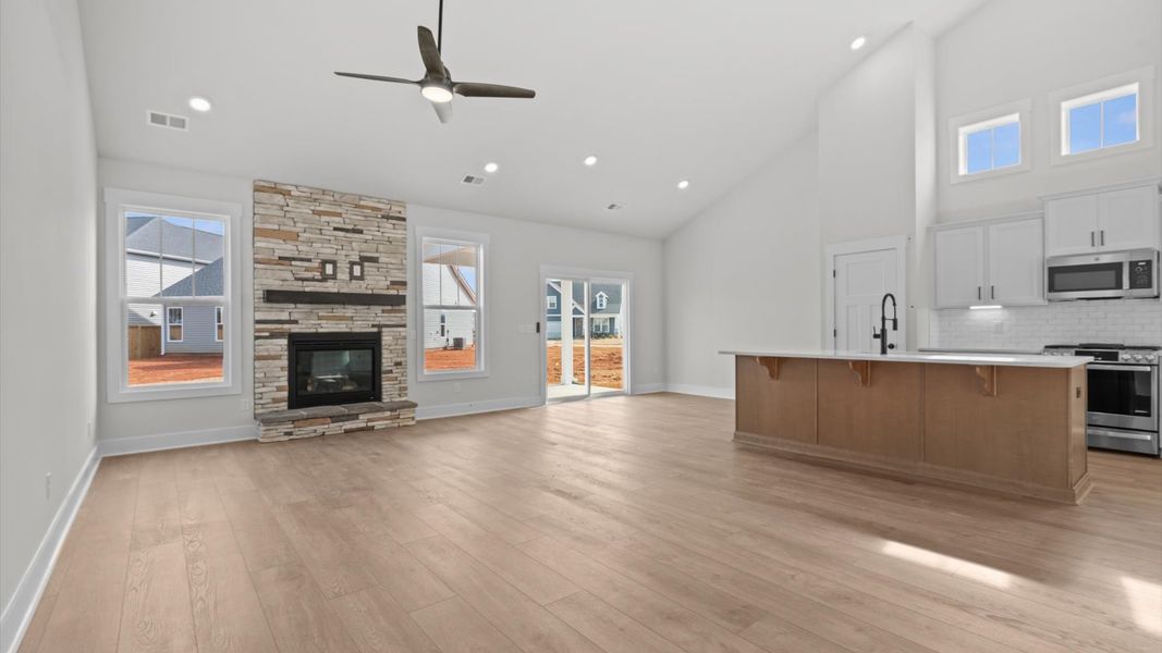 Dramatic two-story family room with accomplished detailing and seamless indoor-outdoor connection