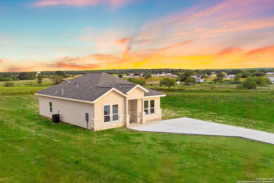 Front exterior of a new home in , La Vernia, TX, highlighting curb appeal (Image 27).