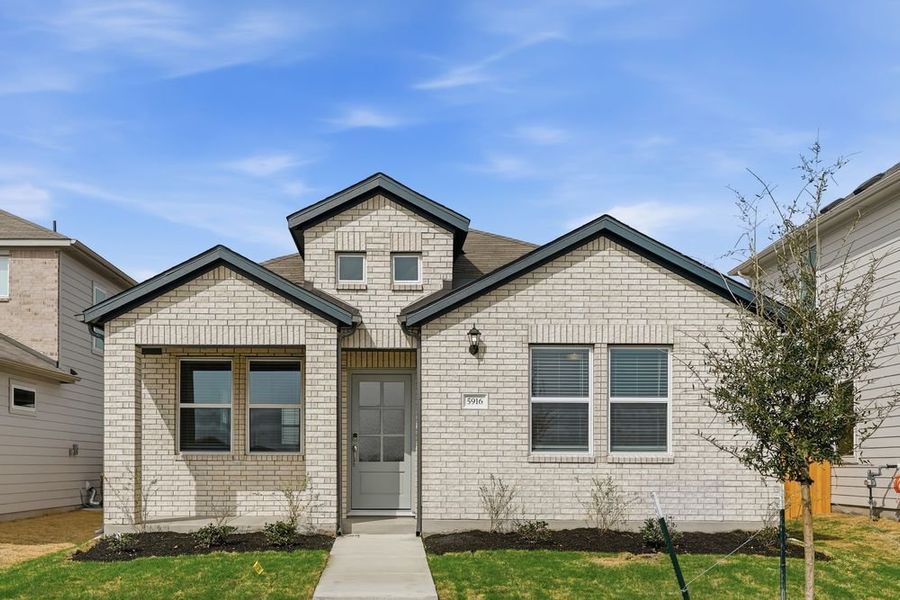 Front exterior of a new home in Longview, Del Valle, TX, highlighting curb appeal (Image 1). Front exterior of a new home in Longview, Del Valle, TX, highlighting curb appeal (Image 1).
