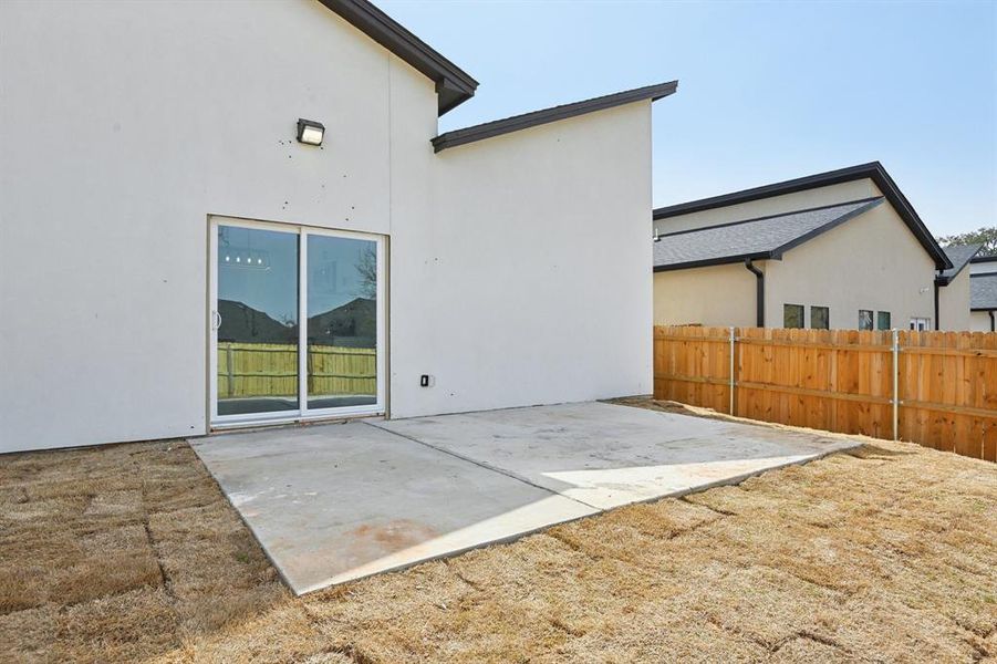 Back of property with a patio, fence, and stucco siding