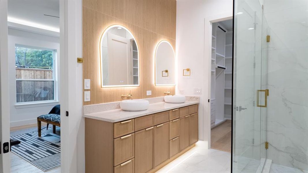 Bathroom with vanity, a marble finish shower, and a closet