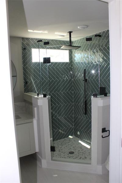 Bathroom featuring vanity and a shower with shower door