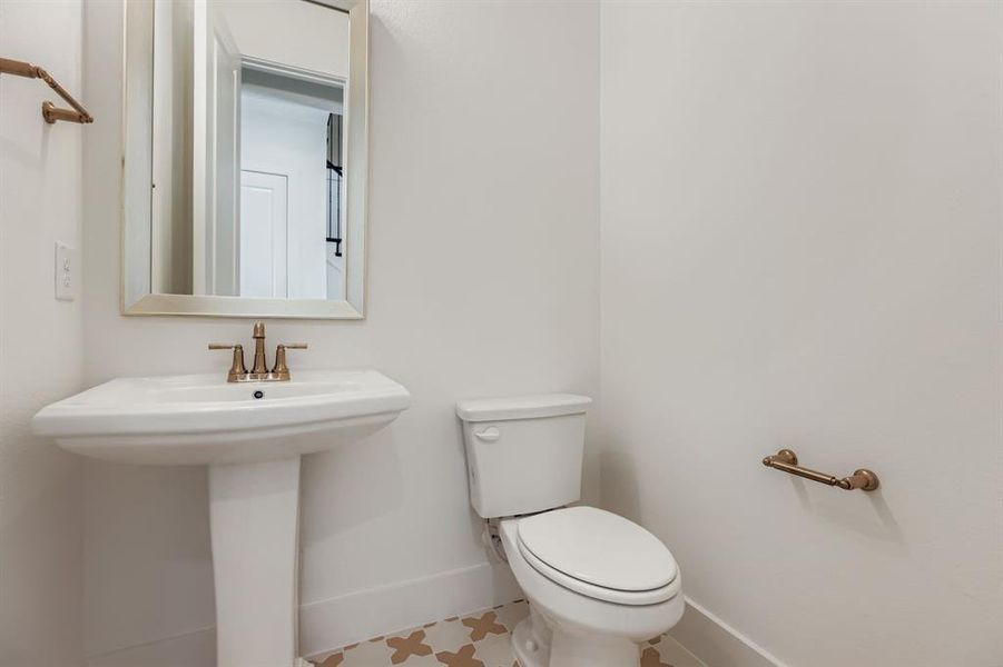 Bathroom featuring baseboards and toilet