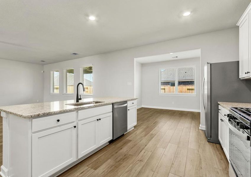 The kitchen over looks the dining room and family room