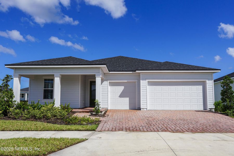 Front exterior of a new home in Reverie at Palm Coast, Palm Coast, FL, highlighting curb appeal (Image 2).