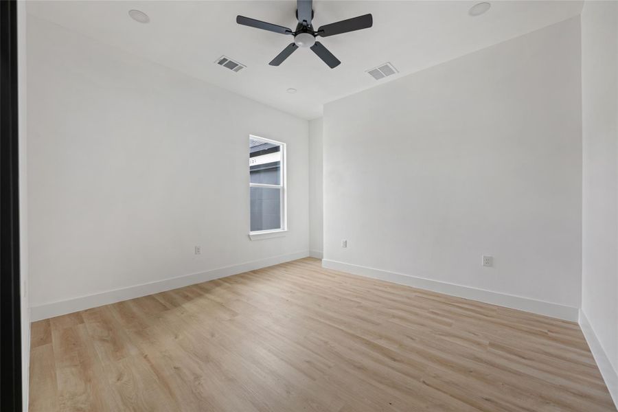 Unfurnished room featuring light wood-style flooring and a ceiling fan Unfurnished room featuring light wood-style flooring and a ceiling fan