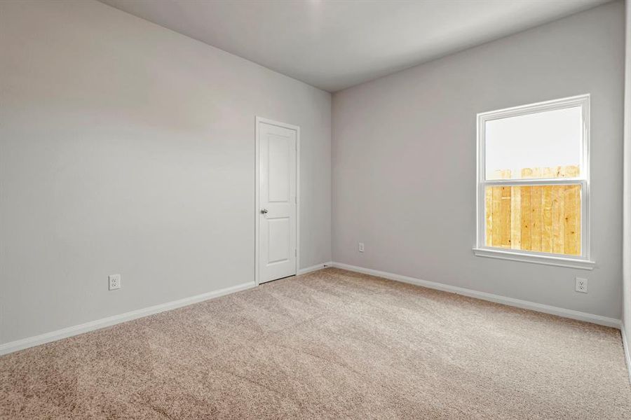 The secondary bedroom is spacious and has a large, energy efficient window.