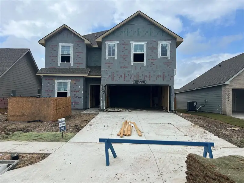 Property in mid-construction with concrete driveway and a garage Property in mid-construction with concrete driveway and a garage