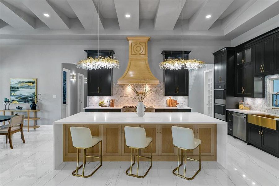 Kitchen with a center island, stainless steel appliances, an inviting chandelier, and decorative backsplash