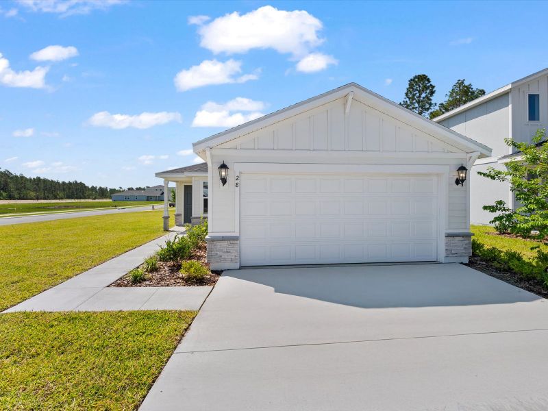 Front exterior of a new home in Flagler Village - Classic Series, Palm Coast, FL, highlighting curb appeal (Image 1). Front exterior of a new home in Flagler Village - Classic Series, Palm Coast, FL, highlighting curb appeal (Image 1).