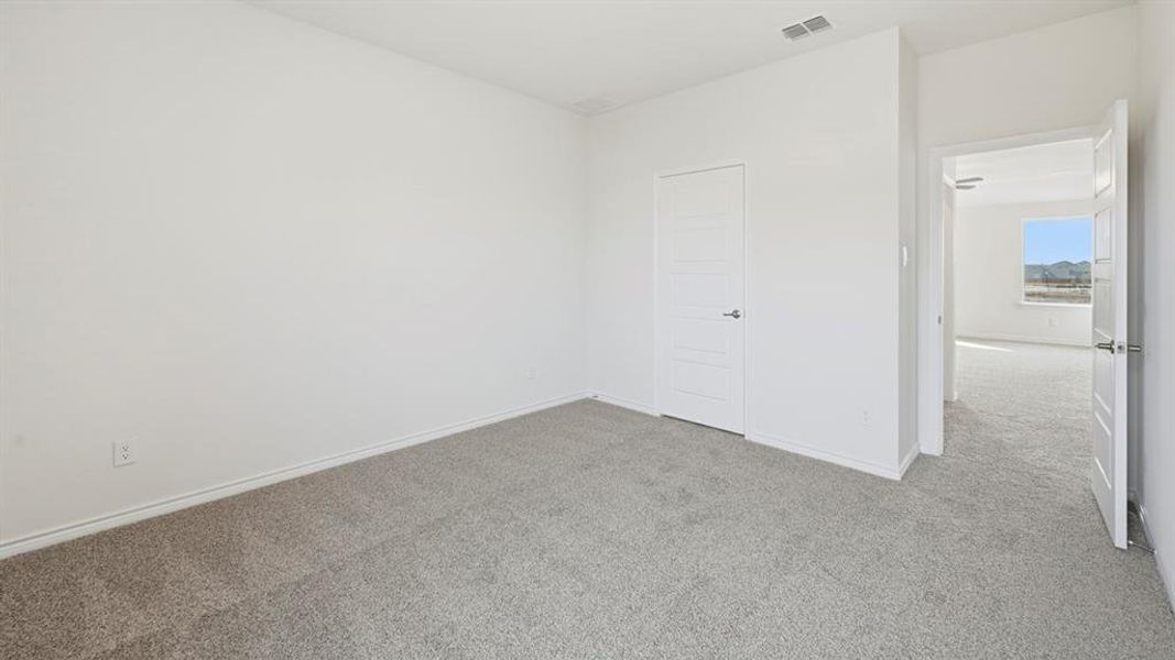 Unfurnished bedroom with carpet floors and baseboards