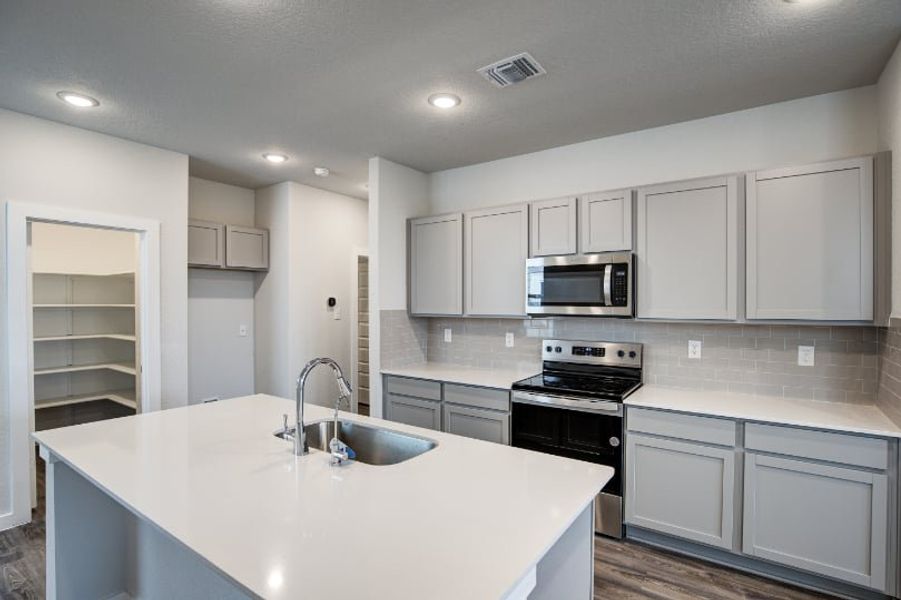 A kitchen with white cabinets. A kitchen with white cabinets.