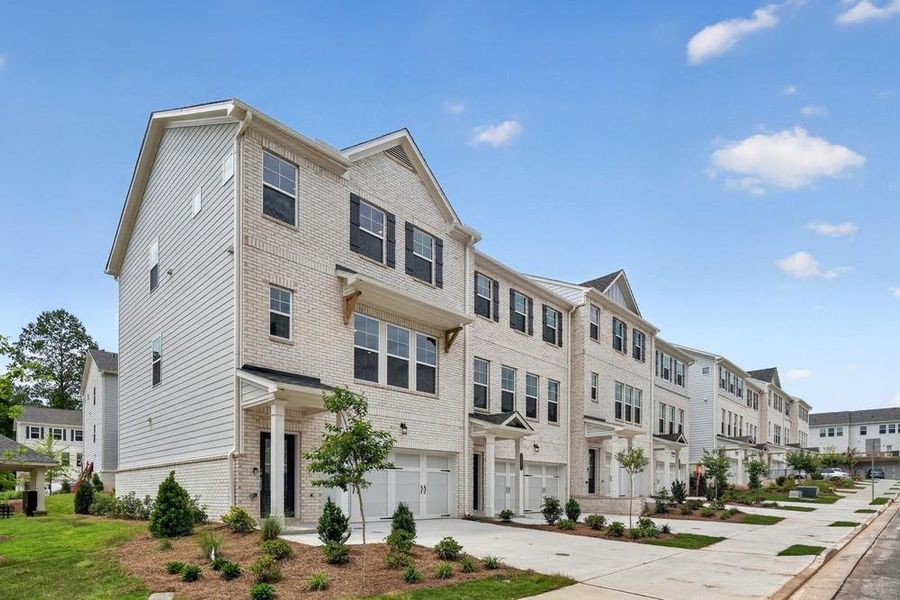 Front exterior of a new home in Somerset at Veterans Memorial, Mableton, GA, highlighting curb appeal (Image 1). Front exterior of a new home in Somerset at Veterans Memorial, Mableton, GA, highlighting curb appeal (Image 1).