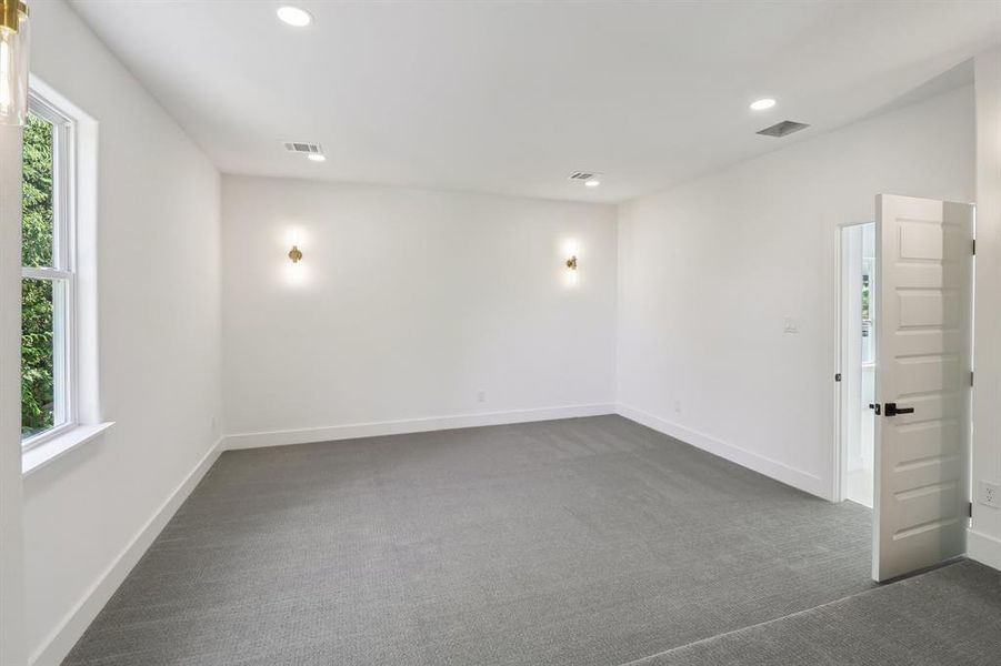 Spare room with dark carpet and recessed lighting