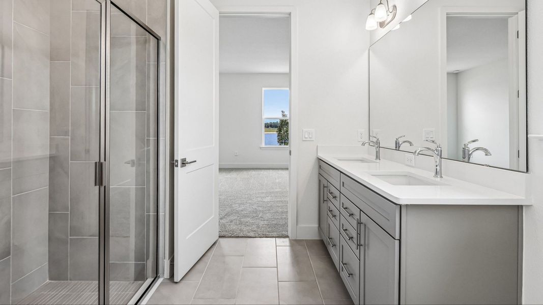 Longleaf Floor Plan Primary Suite Bath with Floor to Ceiling Tile and Glass Encased Shower