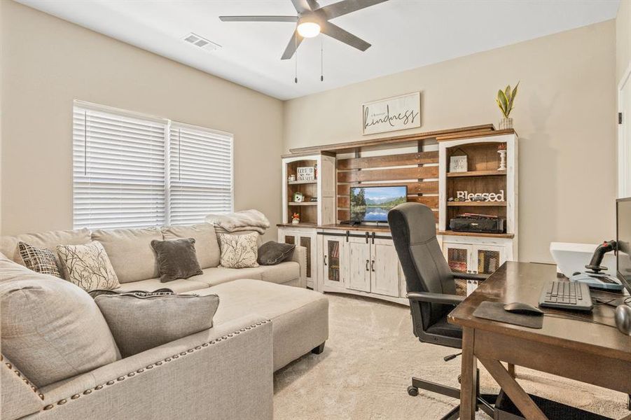 Office space with carpet flooring and a ceiling fan Office space with carpet flooring and a ceiling fan