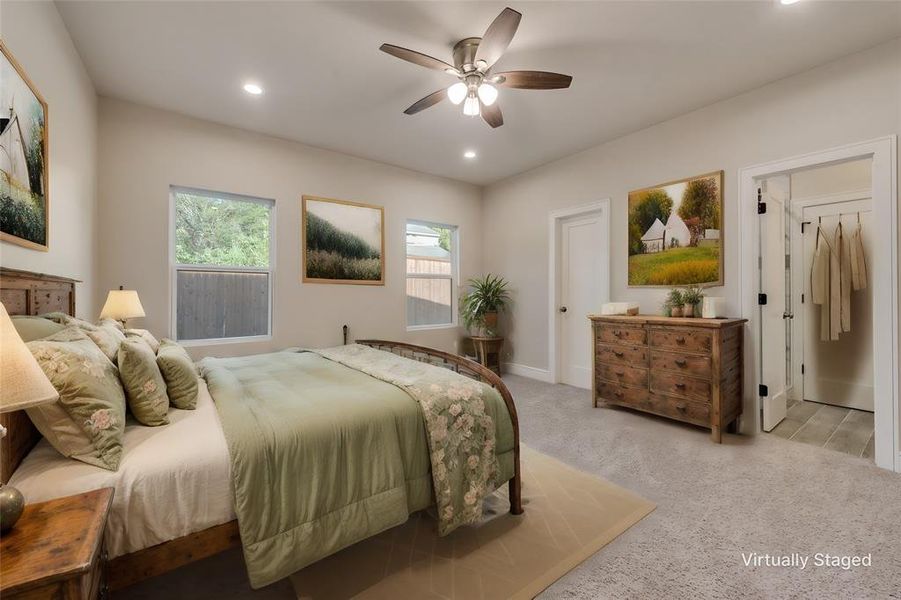 Carpeted bedroom with ceiling fan