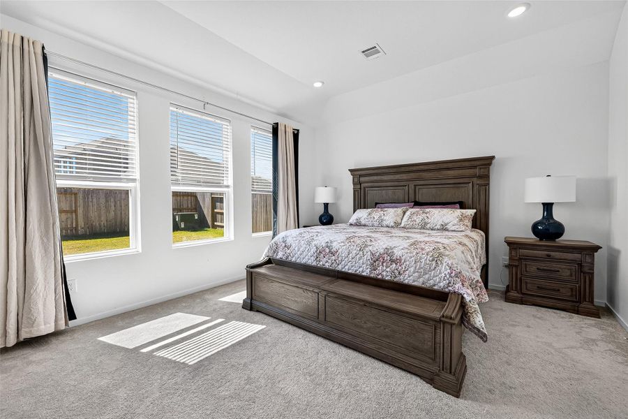 Bright primary suite on the first floor with included window coverings. Bright primary suite on the first floor with included window coverings.