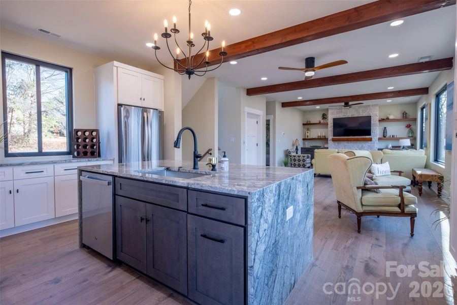 View from the kitchen into large open living space with wooden beams.