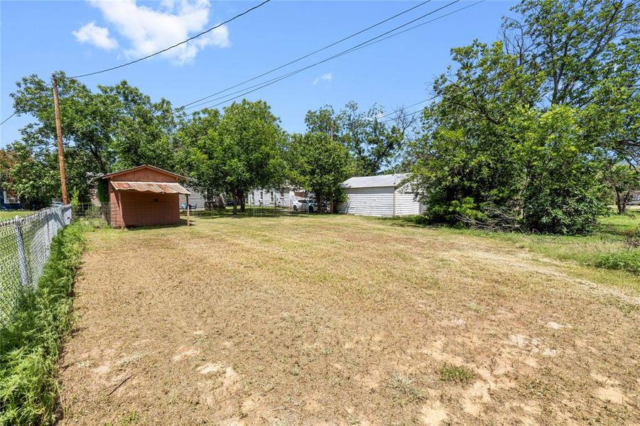 View of yard featuring a storage unit View of yard featuring a storage unit