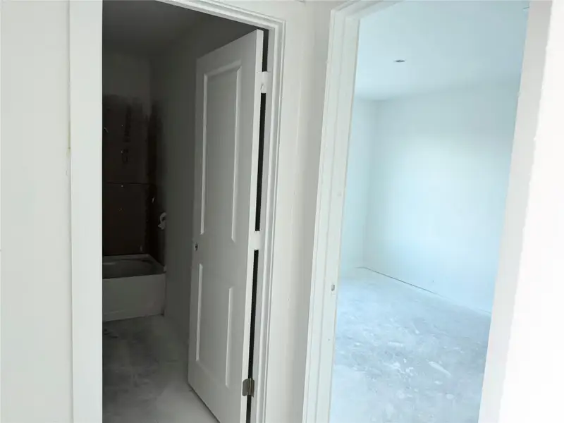 Corridor featuring unfinished concrete floors Corridor featuring unfinished concrete floors