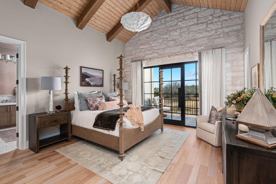 Bedroom with a wooden ceiling with exposed beams, high vaulted ceiling, light wood-style flooring, access to outside, and ensuite bath