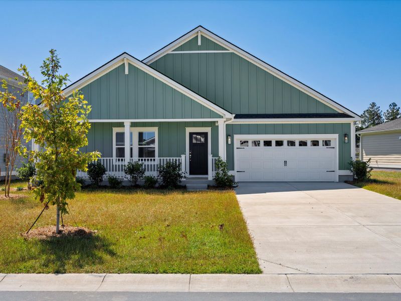 Front exterior of a new home in The Coves at Lakes of Cane Bay II, Summerville, SC, highlighting curb appeal (Image 1). Front exterior of a new home in The Coves at Lakes of Cane Bay II, Summerville, SC, highlighting curb appeal (Image 1).