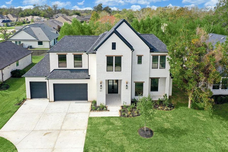 Welcome home through the imposing iron double doors, setting the tone for elegance and bespoke touches. The towering front porch, TRUE WHITE king-size brick, and wood accents create a commanding curb appeal that is truly inviting. Perimeter fence has been installed.