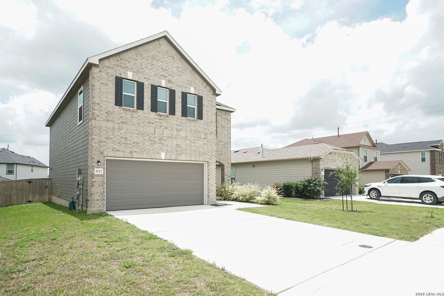 Front exterior of a new home in Parklands, Schertz, TX, highlighting curb appeal (Image 21).