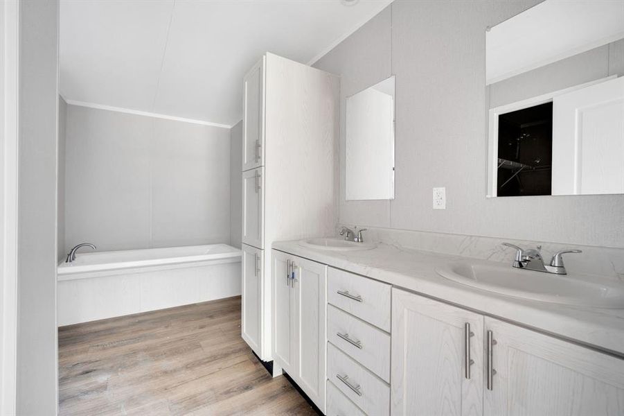 Dual vanity with integrated sinks, chrome fixtures, and a coordinating countertop