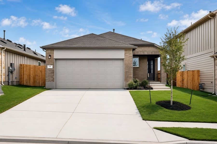 Front exterior of a new home in Sunfield, Buda, TX, highlighting curb appeal (Image 2). Front exterior of a new home in Sunfield, Buda, TX, highlighting curb appeal (Image 2).