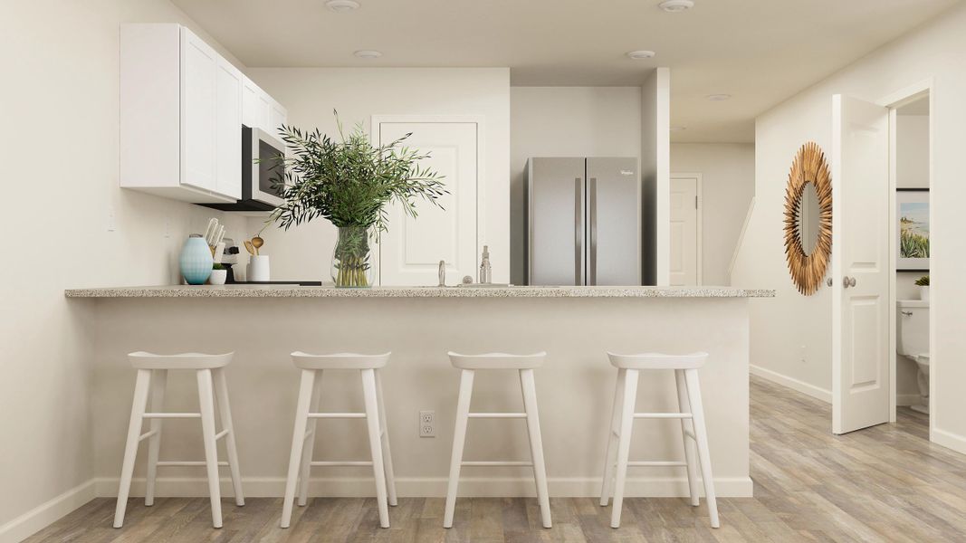 A kitchen with a bar and stools.